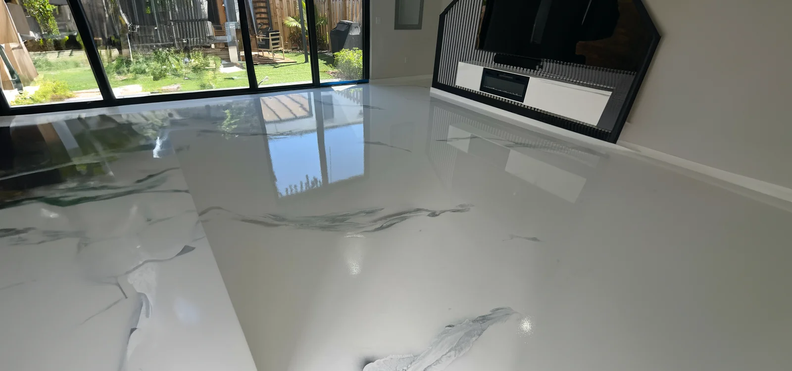 Piso epoxy metálico blanco tipo mármol en sala residencial